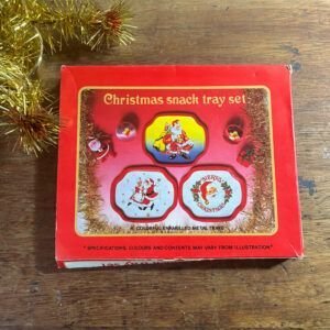 Set of three vintage 1970s colorful enamel tin Christmas snack trays featuring Santa Claus graphics.