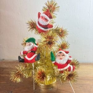Three retro flocked Santa picks displayed tucked inside branches of gold tinsel tree.